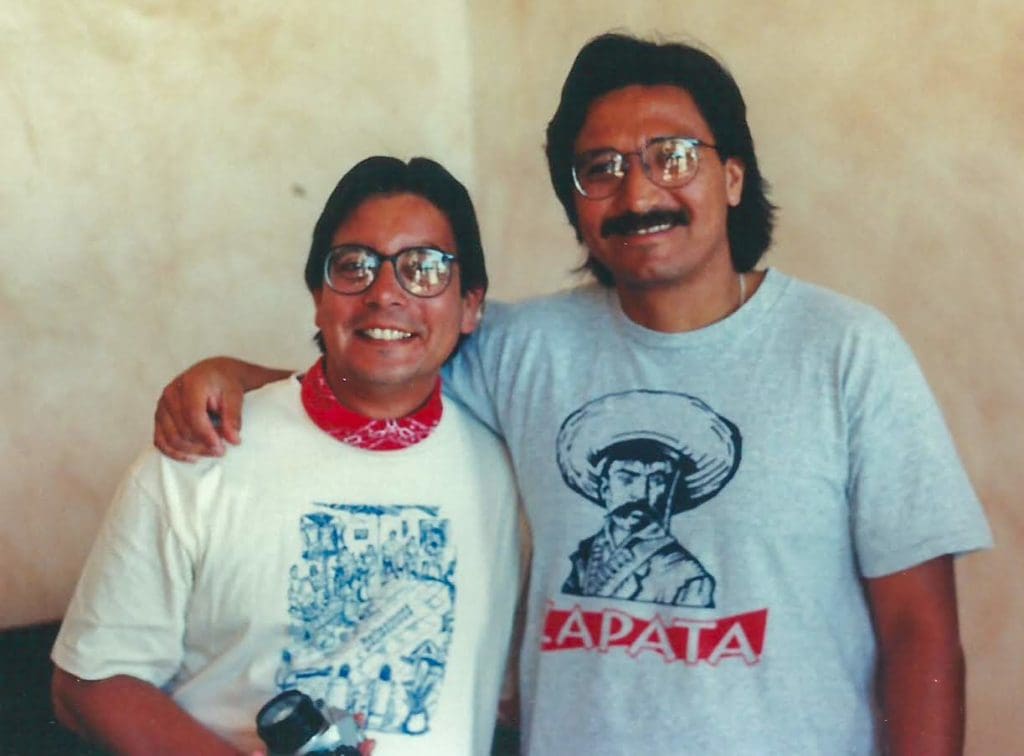 Two men wearing glasses and taking a picture
