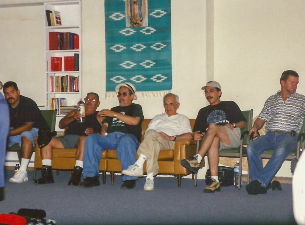 Group of men sitting on sofa and chairs