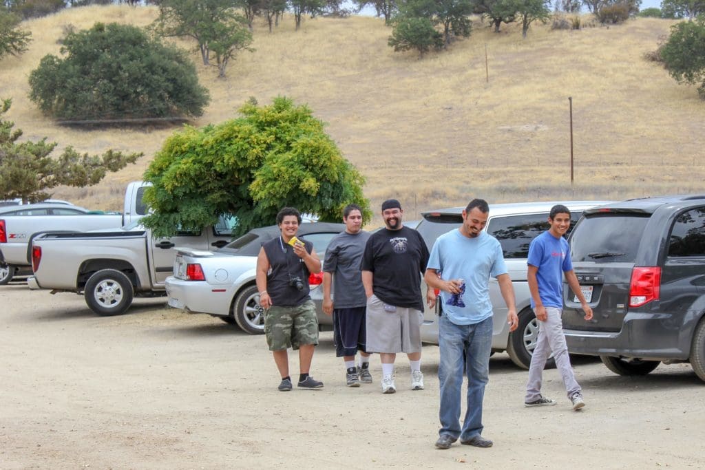 Group of men standing near the car parking area