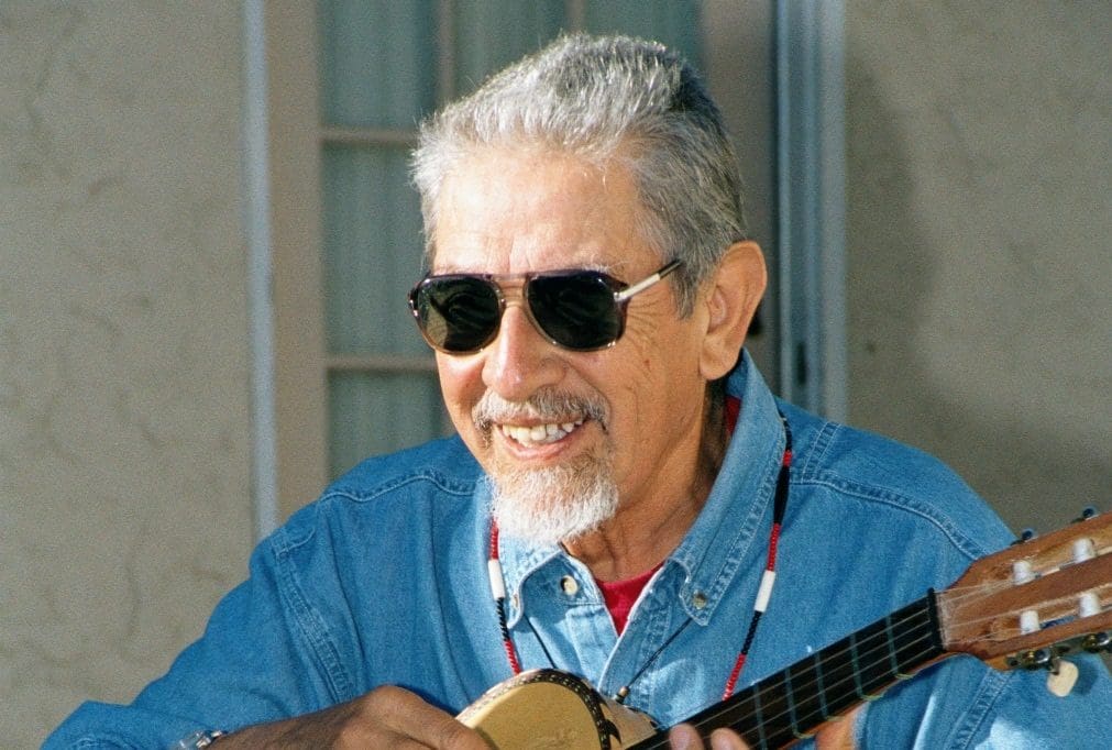 Maestro Jose Montoya wearing sunglasses and playing guitar