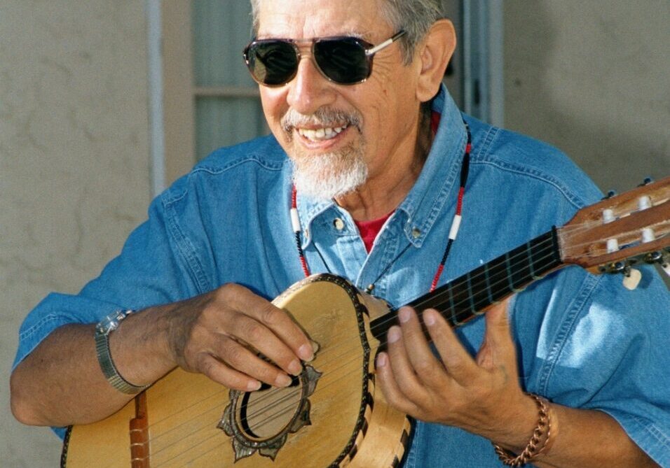 Maestro Jose Montoya wearing sunglasses playing guitar