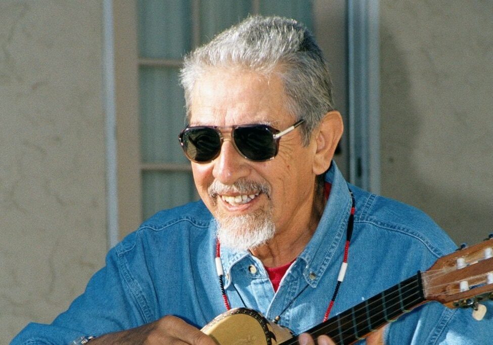 Maestro Jose Montoya wearing sunglasses and playing guitar